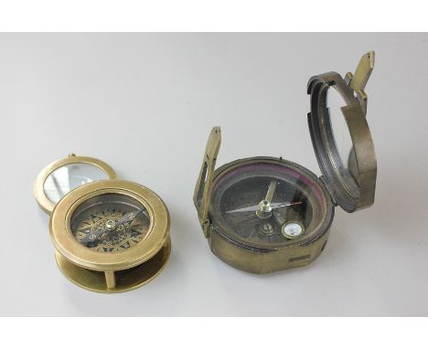A 1914 Brinton brass compass, Thomas J Evans, London, and a T Cooke & Sons compass with magnifying glass