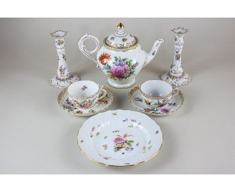 A Dresden porcelain teapot with floral design and gilt embellishment, with two matching teacups and a saucers, and a pair of 