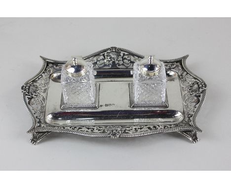 An Edward VII silver inkstand with pierced design, maker William Hutton & Sons, London 1904, with a pair of associated silver