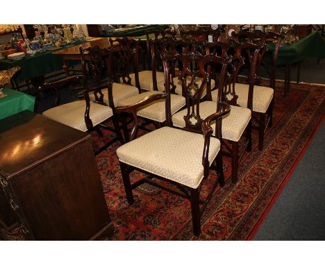 A set of eight Chippendale style mahogany dining chairs with pierced and carved backs, upholstered seats, on square fluted le