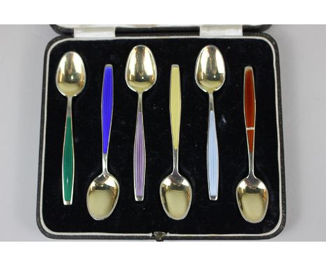 A cased set of six Norwegian silver gilt and enamel coffee spoons with harlequin enamel handles by Jacob Tostrup (a/f red ena