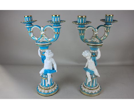 A matched pair of Minton porcelain two-light candlesticks decorated in turquoise and gilt on white ground, each with two loop