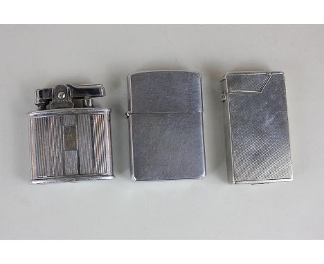 A silver Dunhill cigarette lighter, London 1936, and two others