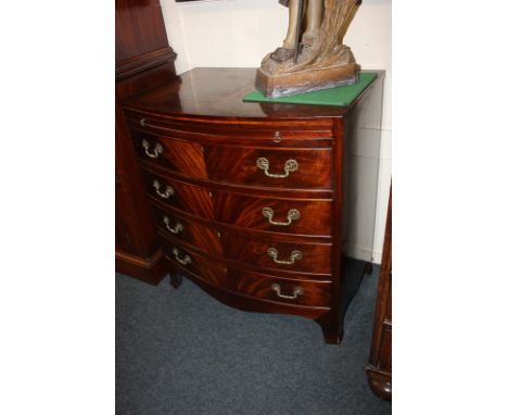 A mahogany small bow front chest of four drawers with slide and brass drop handles, on bracket feet, 76cm