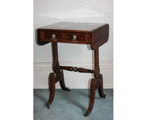 An unusual Regency rosewood sofa table/work table, with line inlay top and two end drop flaps, with one frieze drawer having 