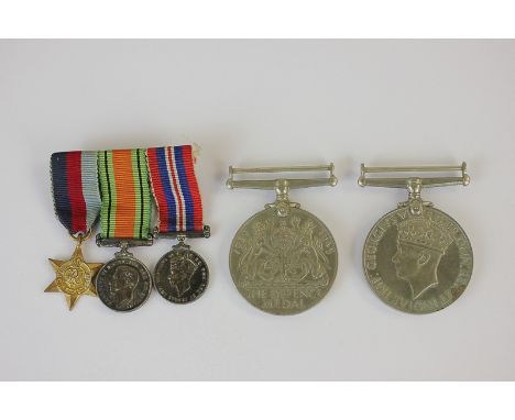 A pair of World War II medals, Defence and 1939-45, and a set of three miniatures to include 1939-45 Star, awarded to Sylvia 