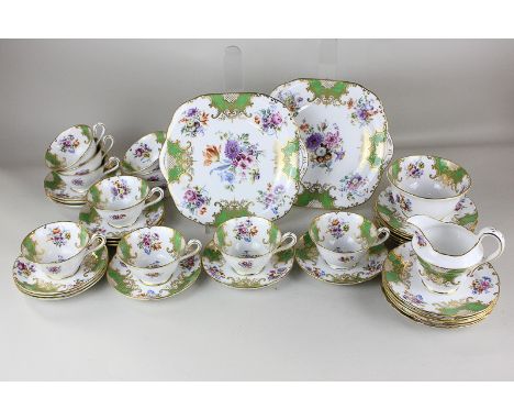 A Grosvenor china Ye Olde English pattern part tea service, decorated in floral green and gold pattern on white ground, compr