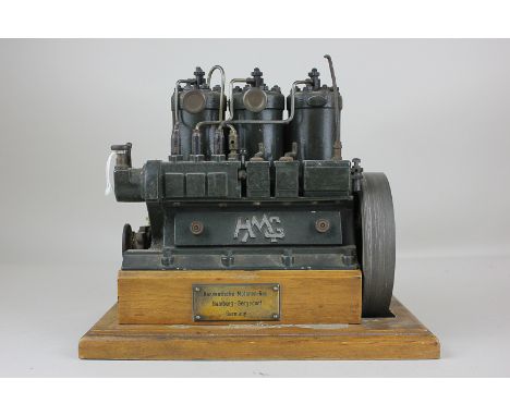 A Hanseatische Motoren-Ges German model of an engine, marked HMG, on wooden plinth with small plaque, 16.5cm high including b