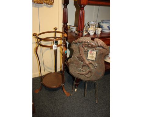 An Arts and Crafts copper stick stand, two bar circular top with three shaped vertical supports inset with blue enamel rounde