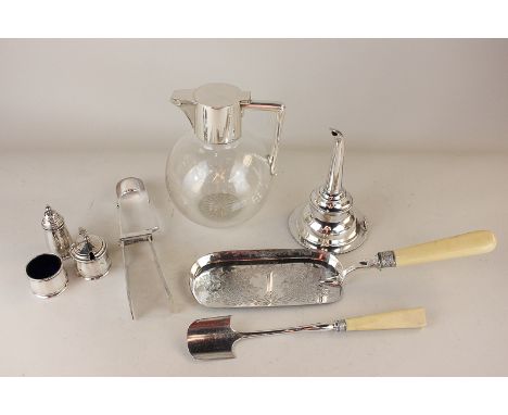 A silver plate mounted glass claret jug, a wine funnel, three piece cruet set, stilton cheese trowel, crumb scoop and cake se