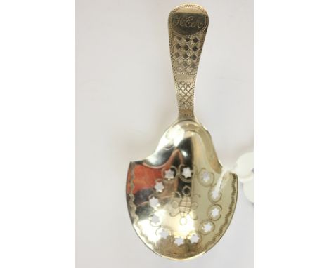 A George III silver caddy spoon, with pierced bowl and engraved handle, initialled, marks rubbed