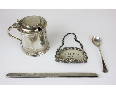 A George V silver mustard, maker Emile Viner, Sheffield 1949, with blue glass liner, a silver whisky decanter label, a mustar