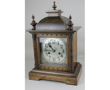 An early 20th century Black Forest mantel clock with 5 inch circular silvered dial, movement striking on a gong, in domed top