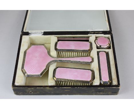 A George VI silver gilt and pink enamel six piece dressing table set in fitted case with mirror, maker Turner & Simpson Ltd, 