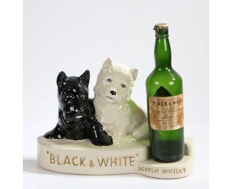 Crown Devon advertising stand for 'Black &amp; White Scotch Whisky', modelled as a black and a white dog on a plinth base, wi