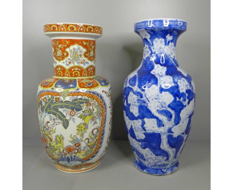 A burnt orange and blue ceramic vase with oriental design with marks on the base and a blue and white tree and blossom design