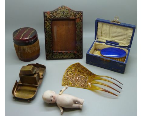 A boulle photograph frame, height 16cm, a travel inkwell in the form of a bag, lacking handles, a small doll, a hair slide, e