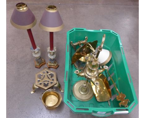A brass four arm oil lamp with shield, a pair of brass candlesticks on wood base with removable top, faux candle, shade holde