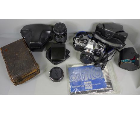 An Olympus OM10 SLR camera with manual adaptor and instructions, an auto Teleplus lens, Vivitar 35-70mm macro zoom lens, a 1: