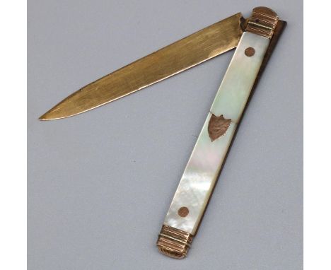 C19th continental soft fruit knife with 8.5cm folding gold blade and mother of pearl handle with shield and oval cartouche, L