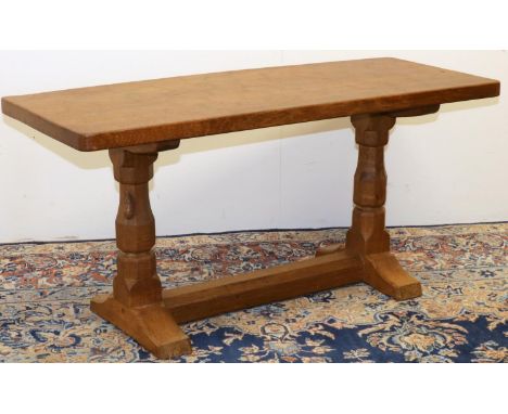 Robert Mouseman Thompson of Kilburn - an oak coffee table, rectangular adzed top on octagonal baluster supports with floor st