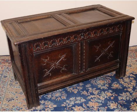 C18th oak coffer, with moulded frame, two panel top and  acrcade carved frieze above two crossed arrow carved panels, on stil