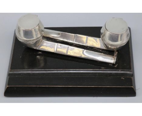 George V rectangular inkstand with two hallmarked silver pipe ink wells, on ebonised wooden base, makers mark obscured Birmin
