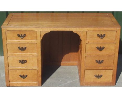 Derek Fishman Slater of Crayke - an oak kneehole desk, moulded top with adzed border and six adzed panel sides, the six drawe