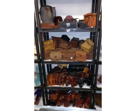 A large quantity of vintage empty camera cases, 4 shelves