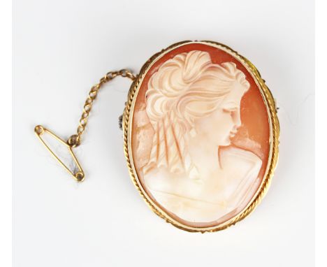 A 9ct gold mounted oval shell cameo brooch, carved as a portrait of a lady, London 1966, weight 12.1g, width 3.1cm.Buyer’s Pr