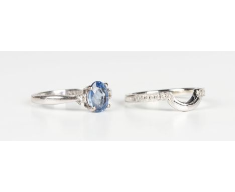 An 18ct white gold, sapphire and diamond three stone ring, claw set with the oval cut sapphire between two circular cut diamo