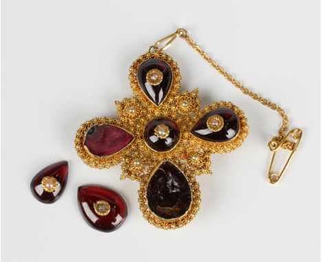 A gold, carbuncle garnet and seed pearl brooch, mid-19th century, probably Indian, set with a circular carbuncle garnet withi