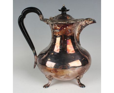 A George V silver hot water pot of low-bellied form with tapering neck and shaped rim, raised on scroll feet, Sheffield 1928 