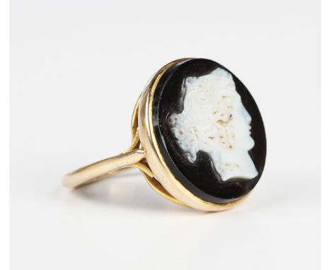 A gold and onyx cameo ring, circa 1910, the circular onyx carved as a portrait of a lady, detailed '9ct', weight 2.9g, ring s