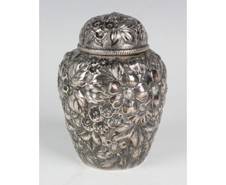 An American sterling silver tea caddy and cover of ovoid form, decorated in relief with flowers and leaves, the base inscribe