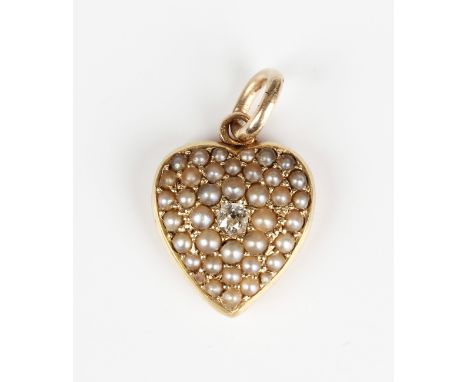 An Edwardian gold, diamond and seed pearl set heart shaped pendant locket, mounted with a cushion cut diamond at the centre, 