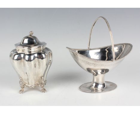An Edwardian silver tea caddy of lobed shouldered form with hinged lid and spiral finial, cast with foliate shouldered paw fe