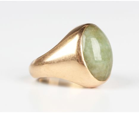 A gold ring, mounted with an oval cabochon jade, unmarked, weight 15.4g, ring size approx P.Buyer’s Premium 29.4% (including 