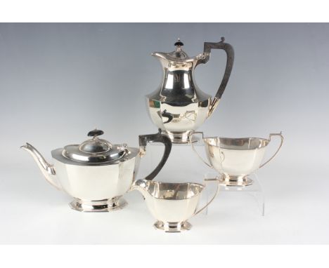 A George V silver four-piece tea set of octagonal faceted oval form on an octagonal foot, comprising teapot, hot water pot, t