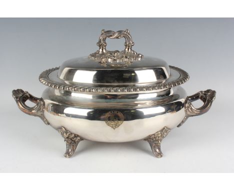 A Victorian plated oval soup tureen and cover with gadrooned rim and applied shell and scroll moulded handles and feet, each 