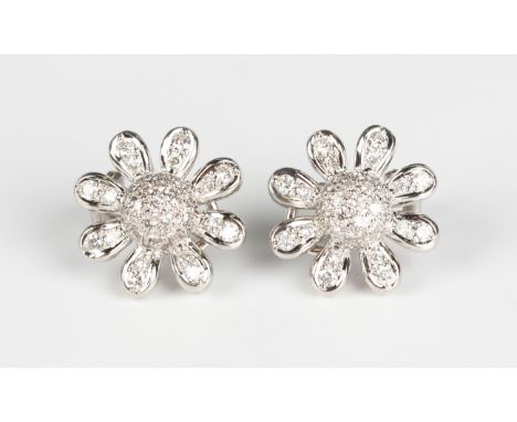 A pair of white gold and diamond earclips, each designed as a daisy flowerhead, mounted with circular cut diamonds, detailed 