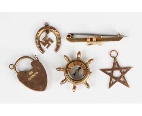 A 9ct gold heart shaped padlock clasp, Birmingham 1904, a 9ct gold mounted compass, designed as a ship's wheel, two gold pend