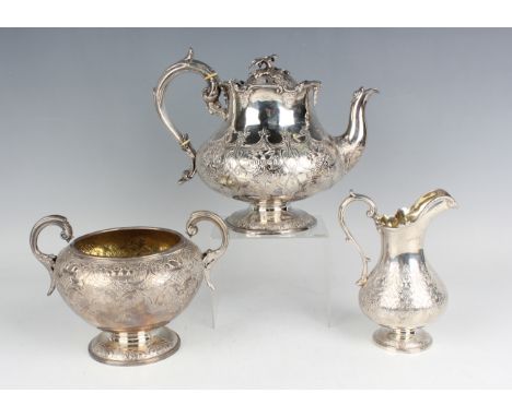 An early Victorian silver teapot of squat circular baluster form with flower finial above chased and embossed fruit filled ba