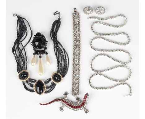 A Butler &amp; Wilson Ltd silver and paste lizard brooch with green paste set eyes and red and colourless paste set body, Lon