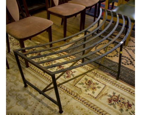 A wrought iron curved garden bench, 142cm wide