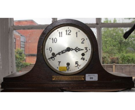 An oak admiral hat mantel clock with silvered dial and inscribed panel, from the staff of the Free Press of Monmothshire, dat