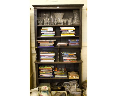 A late Victorian carved stained oak bookcase, with egg moulded cornice over two adjustable shelves, the base with a further a