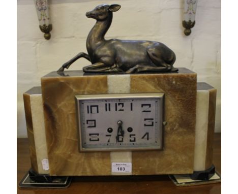 A French Art Deco onyx mantel clock of rectangular form, surrounded by a seated deer figure, the Fini Paris movement stamped 