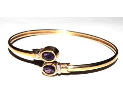 A 9 carat gold hallmarked bangle set with two amethysts in its box, together with a fine 9 carat gold necklace and matching b