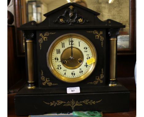 A Victorian slate mantel clock of architectural form, with brass columns and gilt highlights, the drum movement striking on a